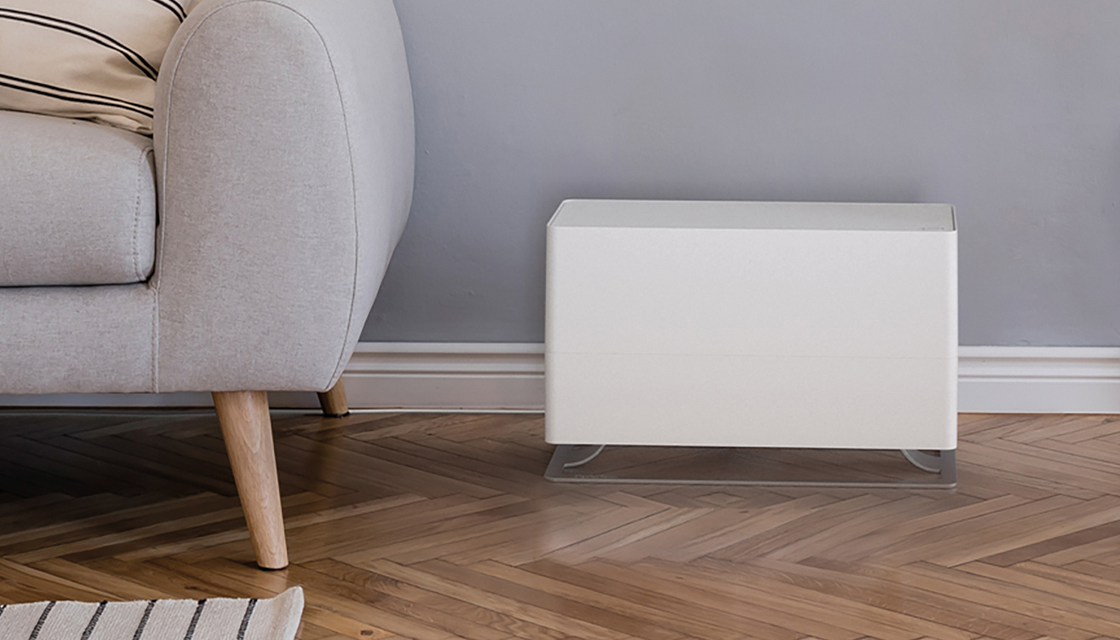 Stadler Form Oskar big white humidifier next to a couch
