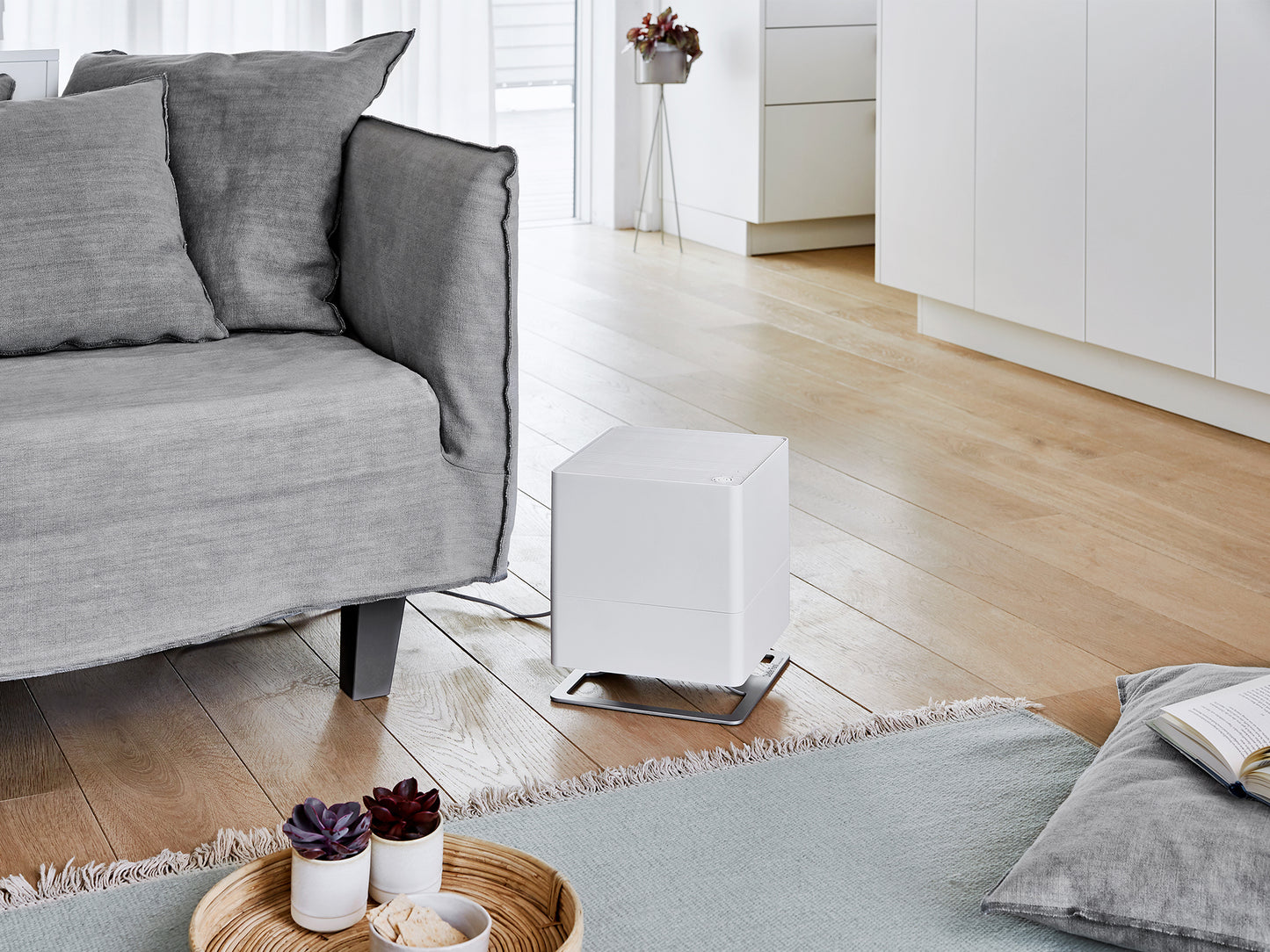 Stadler Form Oskar humidifier in white next to a couch