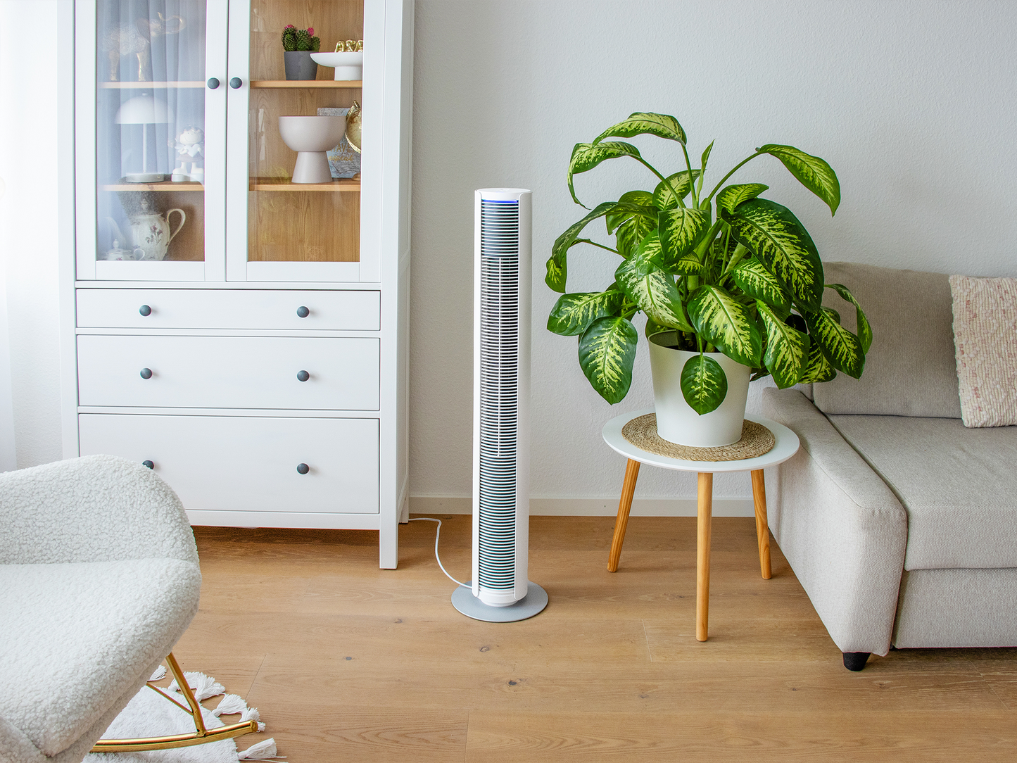 Stadler Form Lifestyle image of Peter fan in white in a livingroom with plants