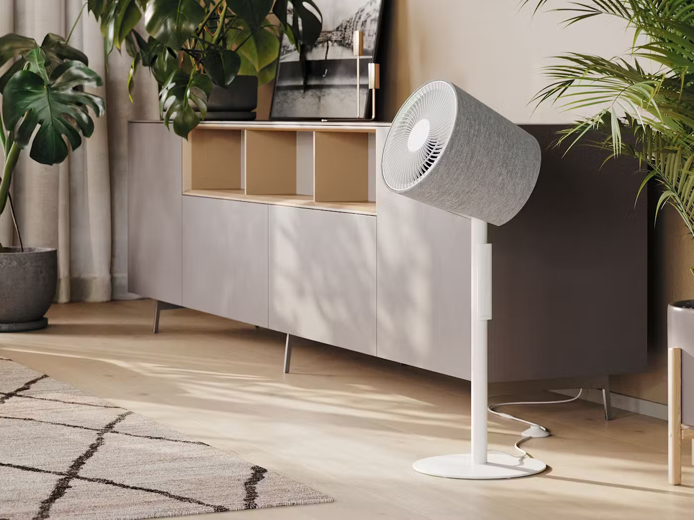 Stadler Form Simon 3d stand fan with remote control in a bright living room area with plants